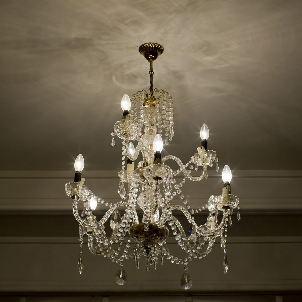 Chandelier installer in London aligning and levelling a pendant light